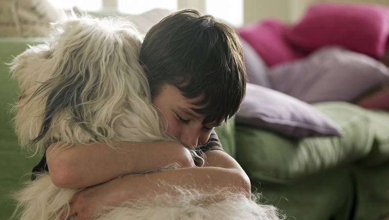 Boy hugging his dog