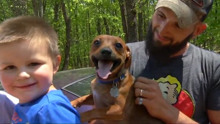 Mason and his dog are held by his Grandma and father.