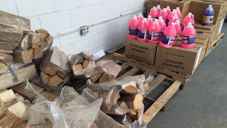 Firewood and antifreeze sits for sasle in front of Lowes Home Improvement in Bowie, Maryland, on January 20, 2016, as weather forecast predict an incoming blizzard to the area. / AFP / JIM WATSON (Photo credit should read JIM WATSON/AFP/Getty Images)