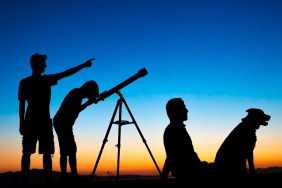 Dad and sons on a clear night looking thru a telescope