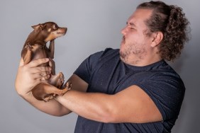 Funny fat man with little dog