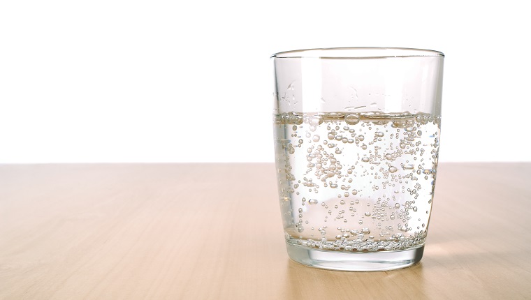 Glass of sparkling water on table