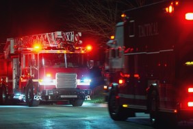 Fire department crew & vehicles on the scene of a devastating house fire.