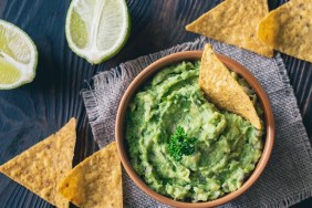 Bowl of guacamole with tortilla chips: top view