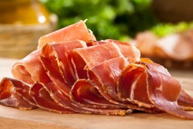 Sliced Italian Prosciutto on Wood Cutting Board