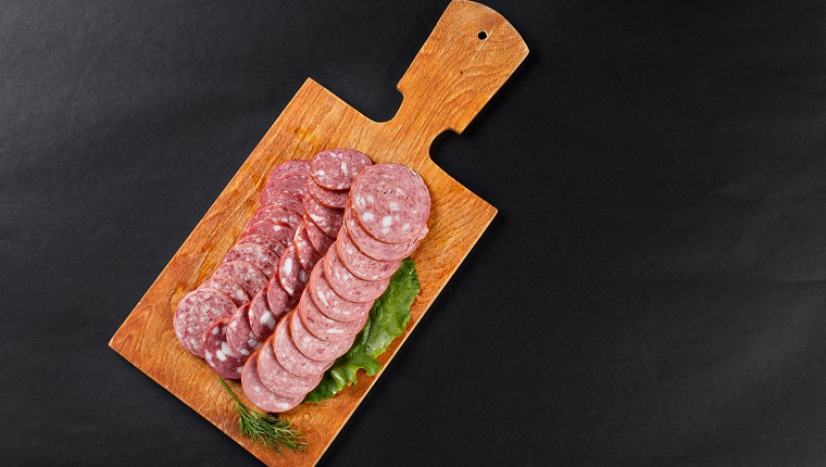 saveloy sausage slices on cutting board topview