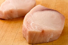 Two fresh swordfish steaks, trimmed and ready for the grill.