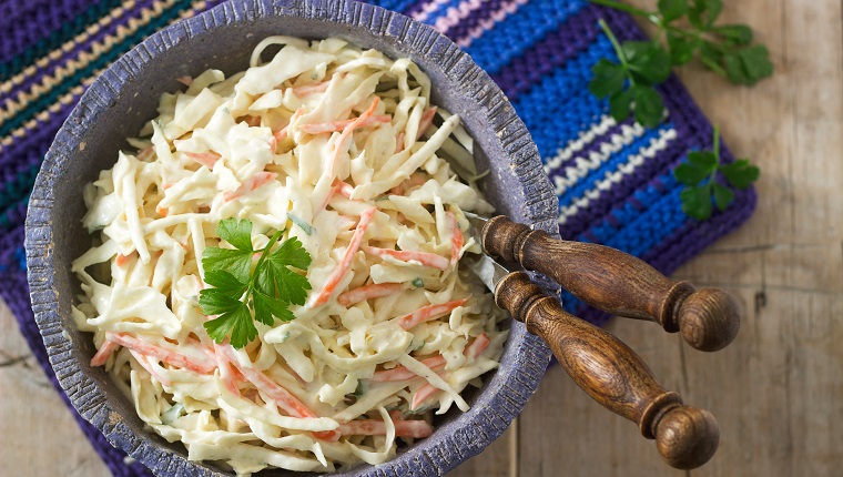 Coleslaw Salad from cabbage and carrots with dressing mayonnaise. Selective focus.