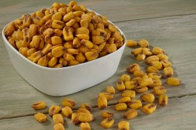 Corn Nuts in white bowl on wooden background