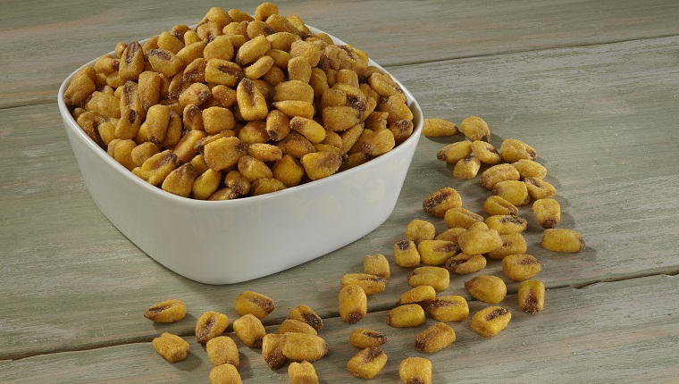 Corn Nuts in white bowl on wooden background