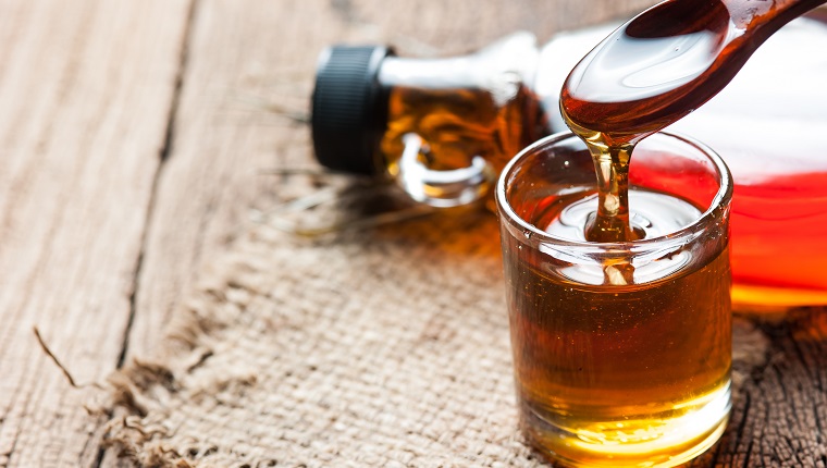 maple syrup in glass bottle on wooden table