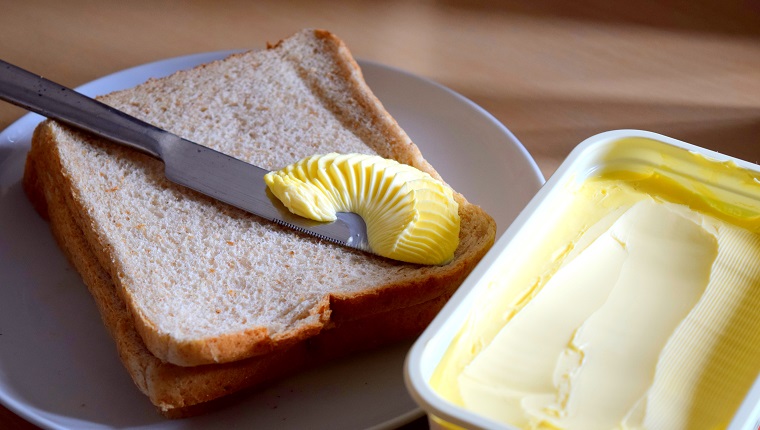 spreading margarine butter onto bread