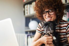 working woman hugging french bulldog best low-maintenance dog breeds