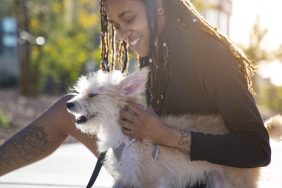 young tattooed person caring for small dog etiquette for pet sitters