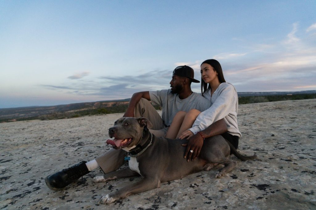 couple sitting with dog after hike dehydrated dog rescued