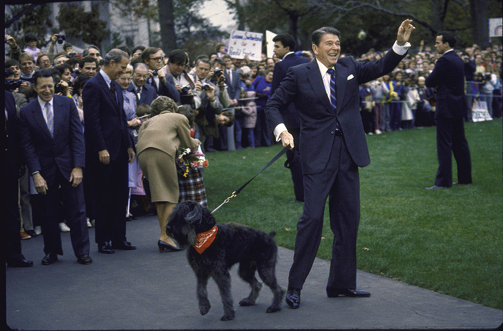 President Ronald Reagan with dog Lucky and wife Nancy (in back), ready to go to Geneva.