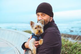 man holding Yorkshire Terrier