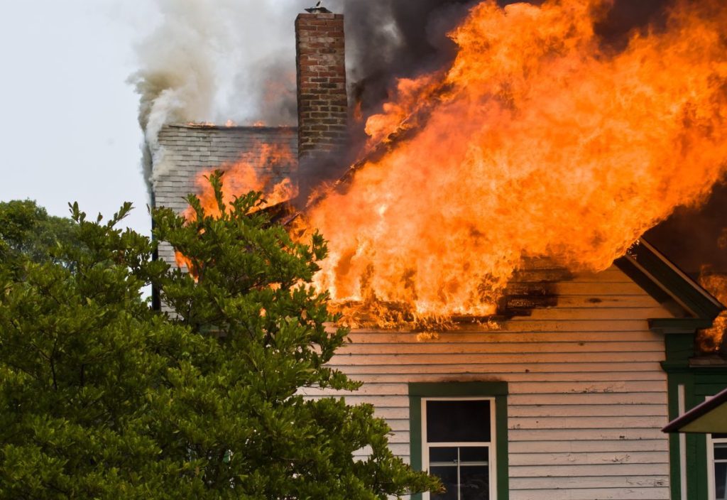 The second story and attic area of a house engulfed in flames like the Pennsylvania house fire where a dog died.