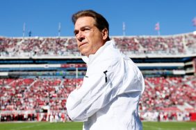 Nick Saban retiring. An image of Saban in a white shirt in a full stadium of Alabama fans.