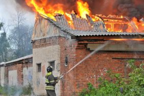 Firefighter extinguishing a building on fire, like the Ohio puppy mill building that went up in flames, killing 70 dogs