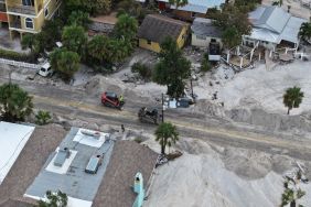 In this aerial view, workers clear the roads of sand and debris after Hurricane Helene hit the area with high surge waters as it passed offshore on September 28, 2024, in Treasure Island, Florida.