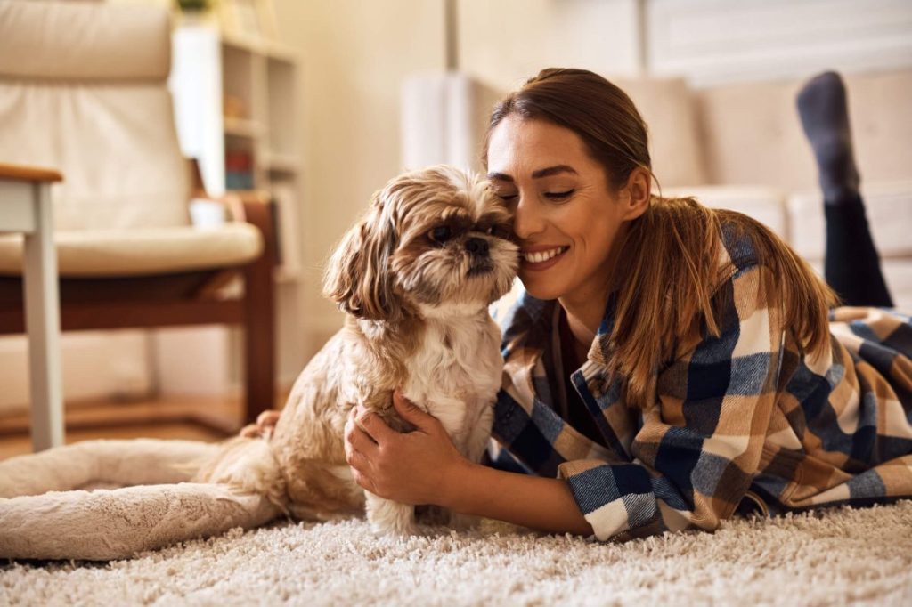 Woman and Shih Tzu enjoying each other’s company.