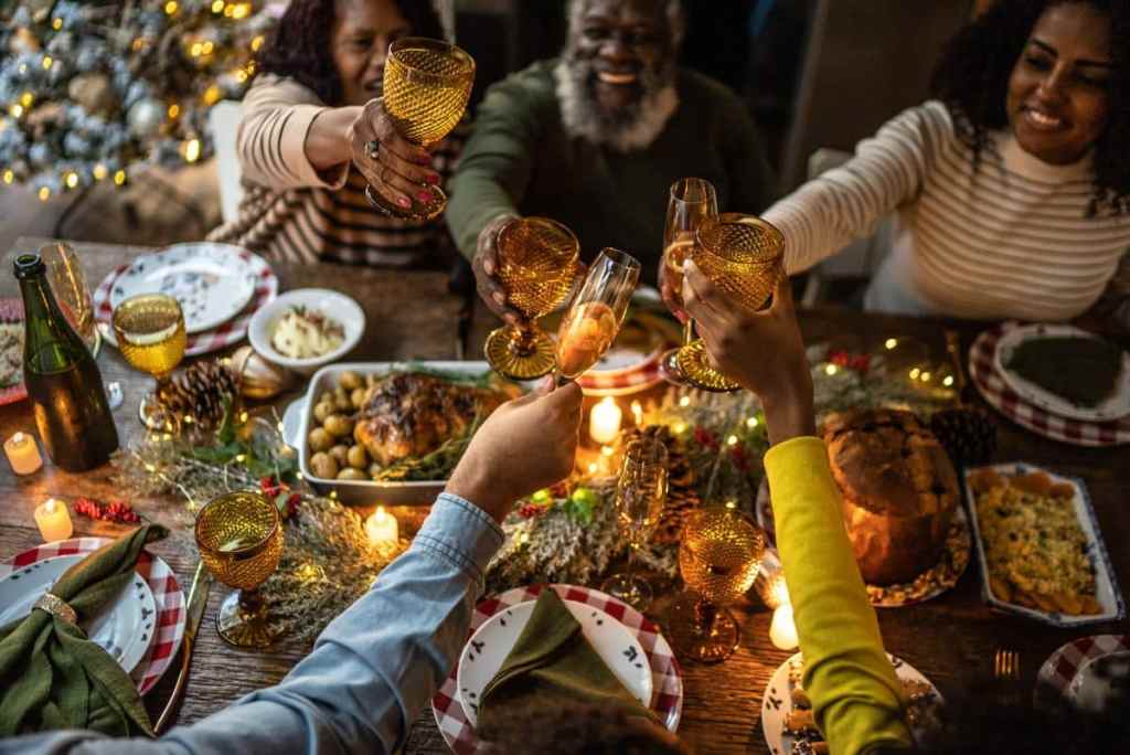 Family toasting on Kwanzaa feast at home.
