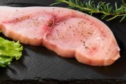 A photo of a raw filet of swordfish, which is not safe for dogs to eat. While dogs can eat swordfish because it's not considered toxic, they shouldn't due to higher levels of mercury.