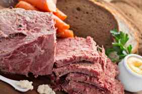 A close up shot of some corn beef, slices of rye bread, some horseradish and mustard. However, it's important to remember corned beef is not safe for dogs,
