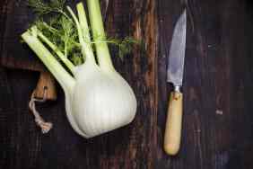 A fennel bulb on a wooden cutting board.