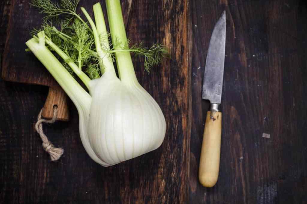 A fennel bulb on a wooden cutting board.