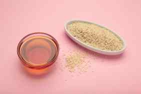 Sesame seeds and sesame oil in bowl.